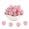A pile of pink rhinestone acrylic beads for jewelry making