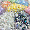 A display of colorful acrylic bow and flower beads in various shades and sizes for DIY jewelry making