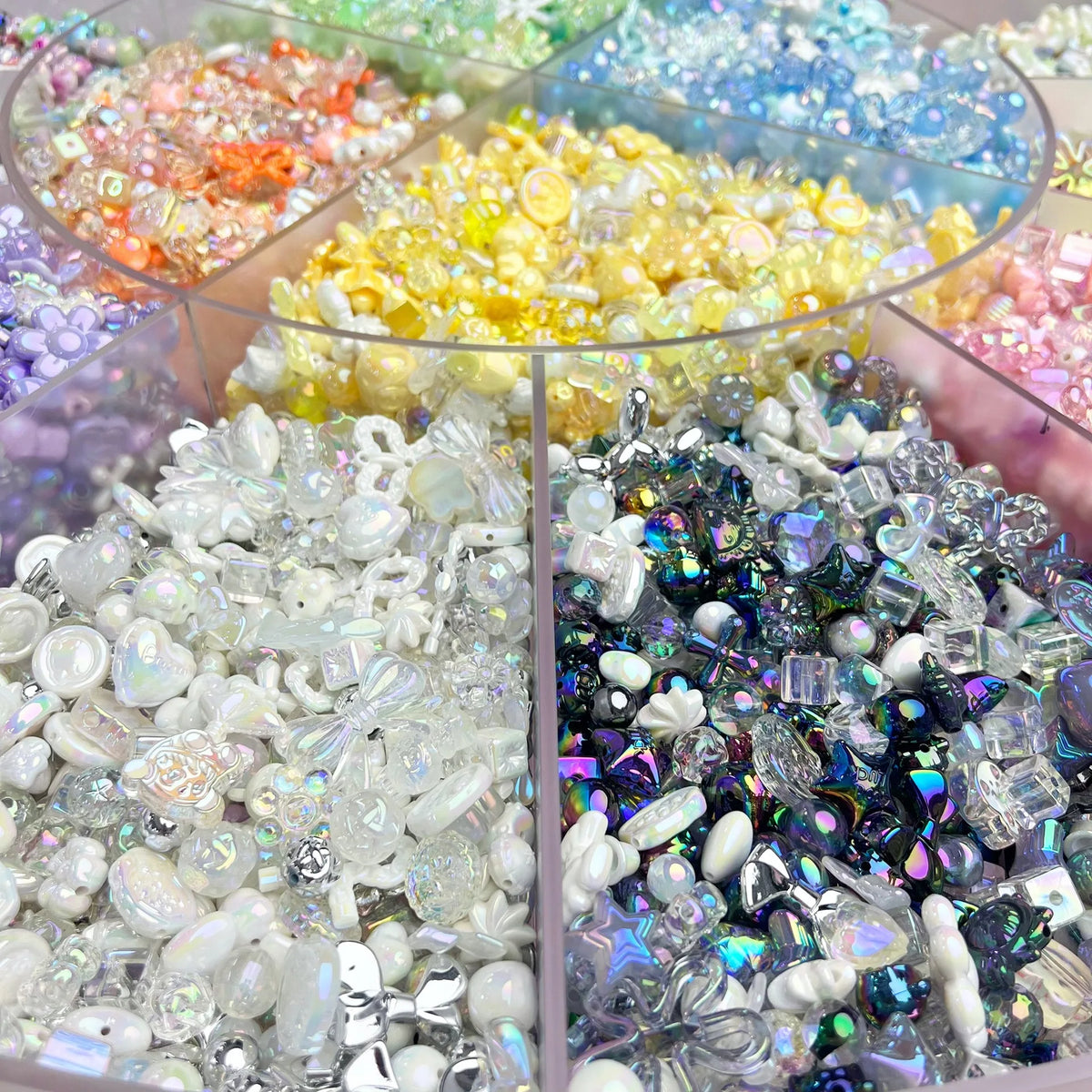 A display of colorful acrylic bow and flower beads in various shades and sizes for DIY jewelry making