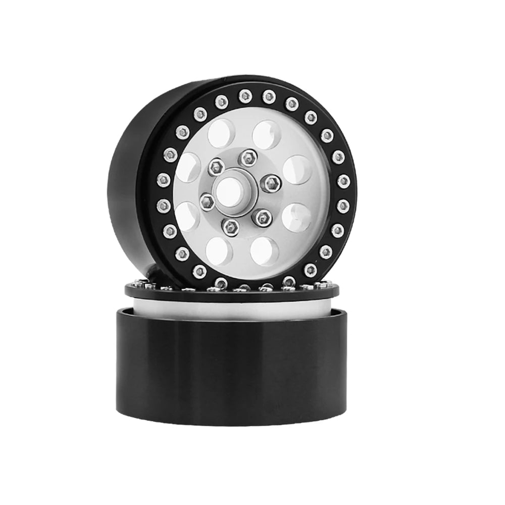 Black beadlock wheels for an RC crawler with a removable hex hub and multiple mounting holes.