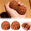 A hand holds several brown, textured walnuts used for stress relief and daily relaxation.