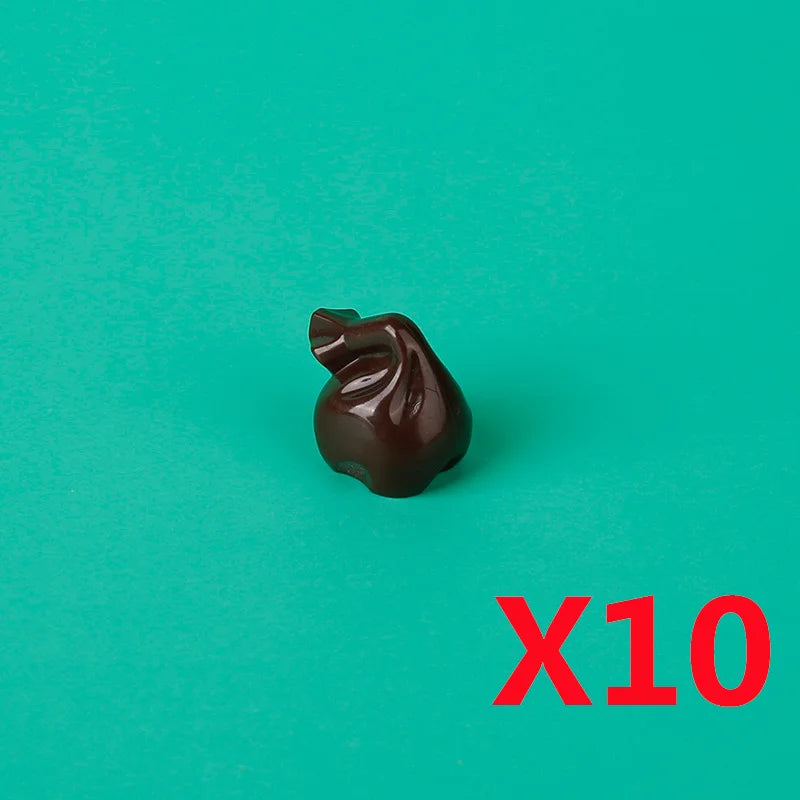 A single dark brown building block treasure chest is shown against a teal background with the text X10.