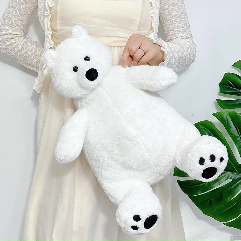 A white plush polar bear stuffed animal being held by a person wearing a light-colored dress.