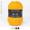 A ball of bright yellow milk cotton yarn labeled 67# 亮黃 for knitting and crochet.