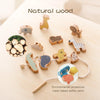 A set of natural wood animal toys and stacking pieces used for thread crafting and stacking, with a paint bottle nearby.