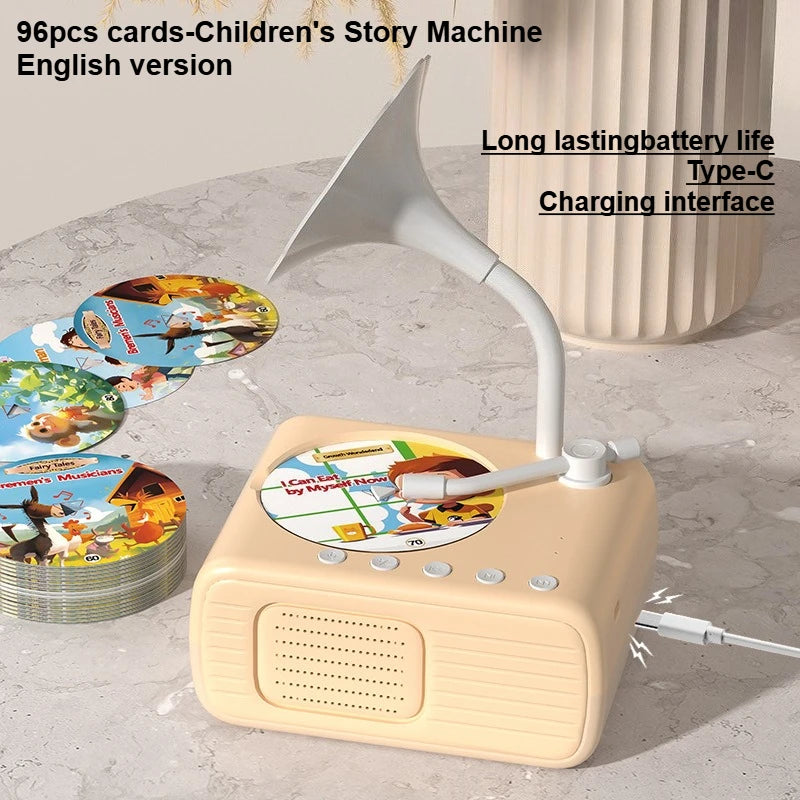 A beige story machine device with a white horn is shown next to a stack of colorful learning cards.
