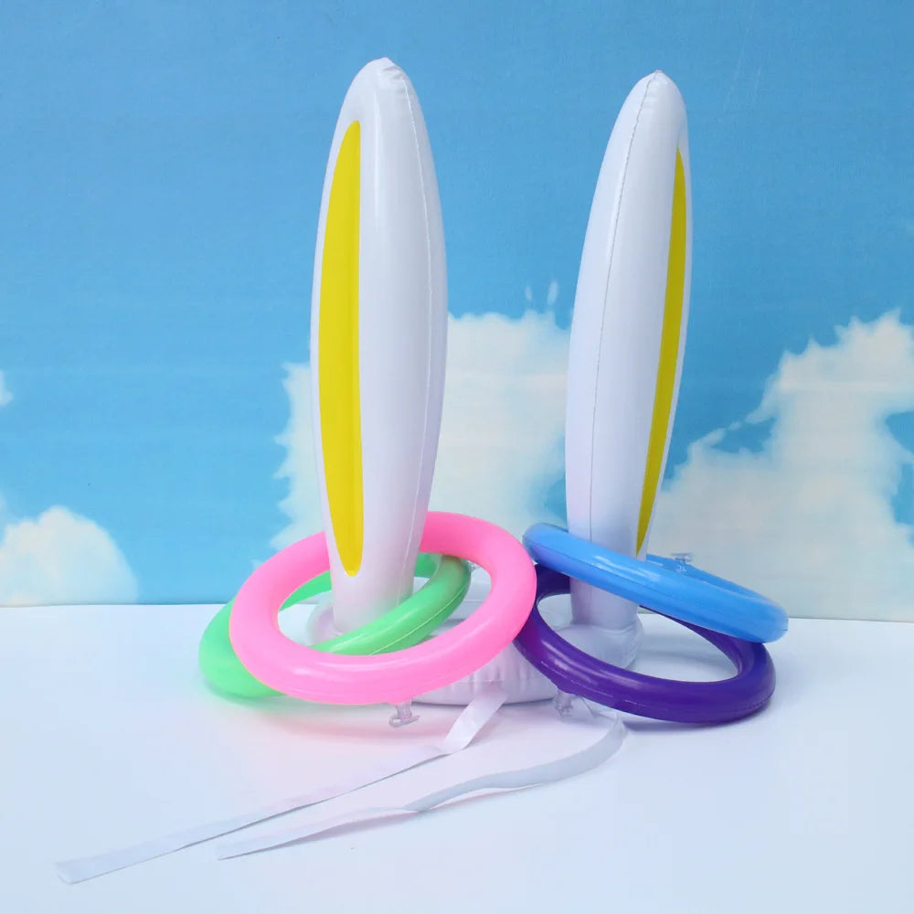 A set of colorful plastic Easter egg and spoon race game pieces including white, yellow, green, pink, and purple rings.