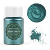 A glass jar of dark green pearl powder next to a circular swatch of the same color and scattered powder.