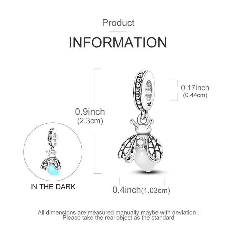 Sterling silver charm beads featuring an ornate butterfly design shown in the dark