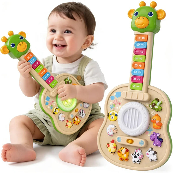 A baby is holding a green educational animal sound guitar toy with various animal figures and keys.