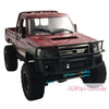 A maroon RC crawler truck with a heavy duty front bumper and aftermarket tires.