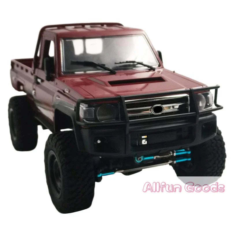 A maroon RC crawler truck with a heavy duty front bumper and aftermarket tires.