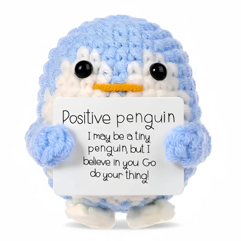 Handmade crochet blue penguin doll with a white card that reads I may be a tiny penguin but I believe in you go do your thing