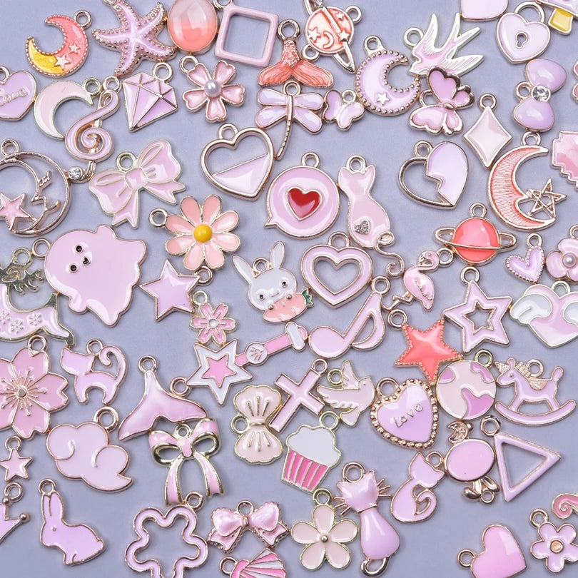Assortment of gold-tone enamel charms for jewelry making featuring various shapes and designs in pink and gold tones