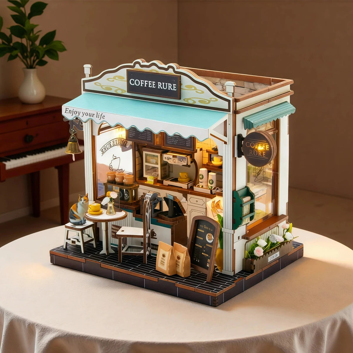A detailed wooden dollhouse kit of a coffee shop featuring an awning and display window.