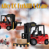 A red alloy forklift and crane truck model with a yellow load and a remote control gamepad.
