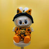 A cute doll wearing a Halloween pumpkin costume set with orange and black patterned clothing.