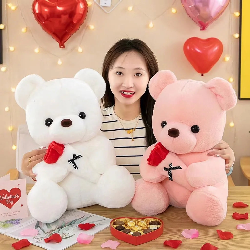A woman holds a white plush bear and a pink plush bear against a light background with red hearts and pink petals.