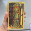 A golden foil tarot card titled La Suma Sacerdotisa featuring a female figure and Roman numerals B and J.