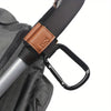 A close-up of a black and brown strap with a leather accent, used for heavy-duty stroller hooks.
