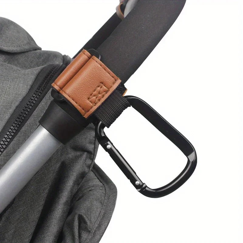 A close-up of a black and brown strap with a leather accent, used for heavy-duty stroller hooks.