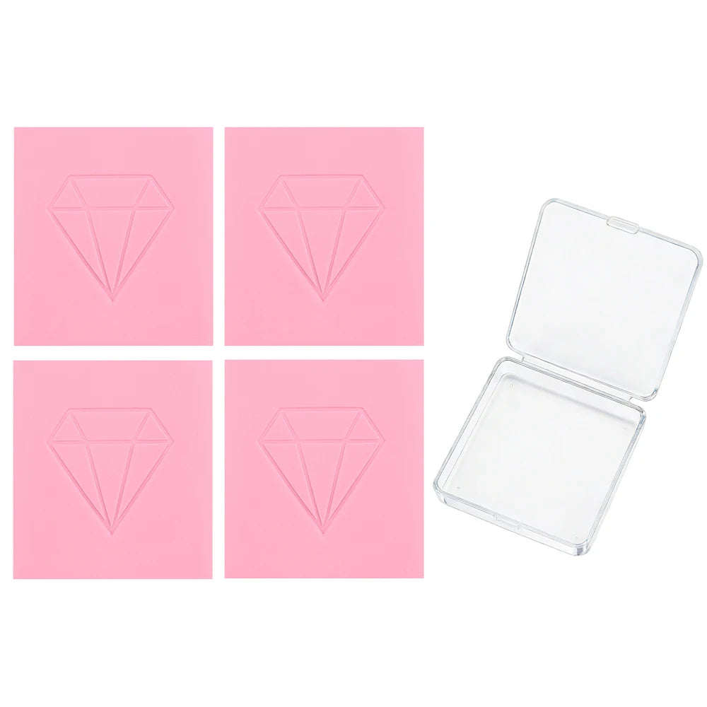 A set of four pink cards featuring diamond shapes, alongside an open clear plastic box for the clay.