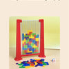 A single player successfully fills a glass frame with colored puzzle blocks shaped like a die.
