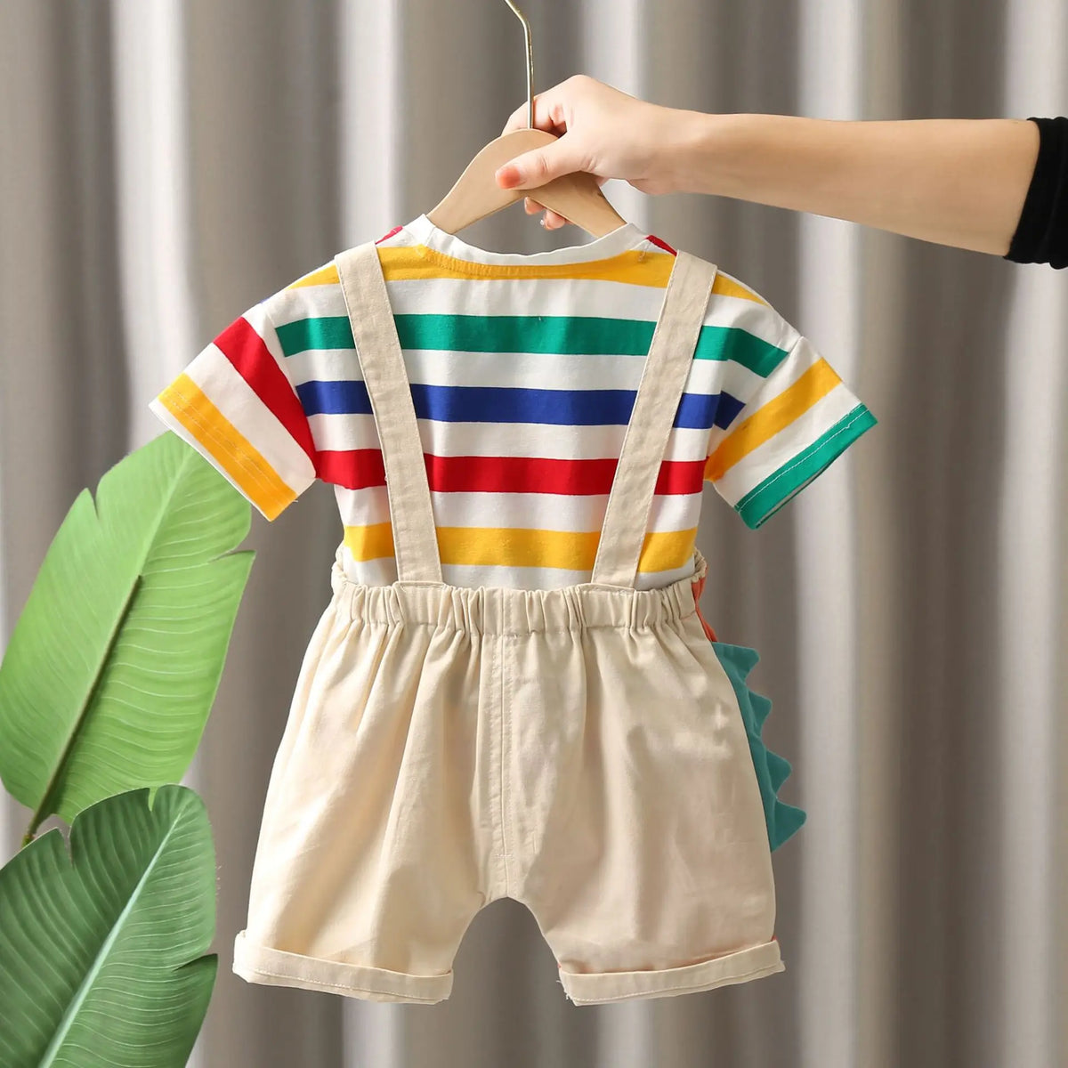 A child's two-piece outfit set featuring a striped shirt and matching shorts, displayed on a hanger.