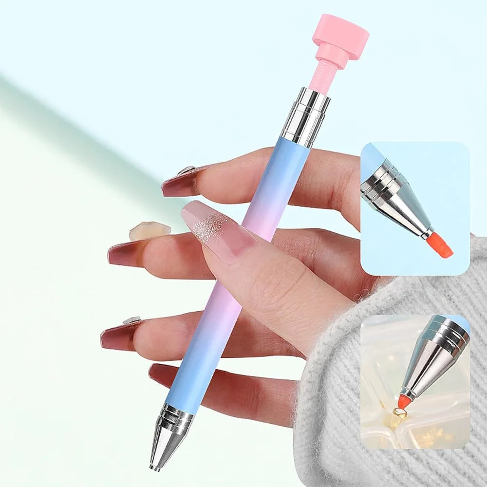 A hand holds a refillable gradient diamond picking pen with a pink and blue body and a rotating wax tip for nail art.