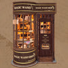 A wooden miniature kit of a magic wand shop display featuring shelves and glass cabinets.