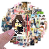 A hand holds a collection of K-ON! anime stickers featuring cute guitar girls and characters.