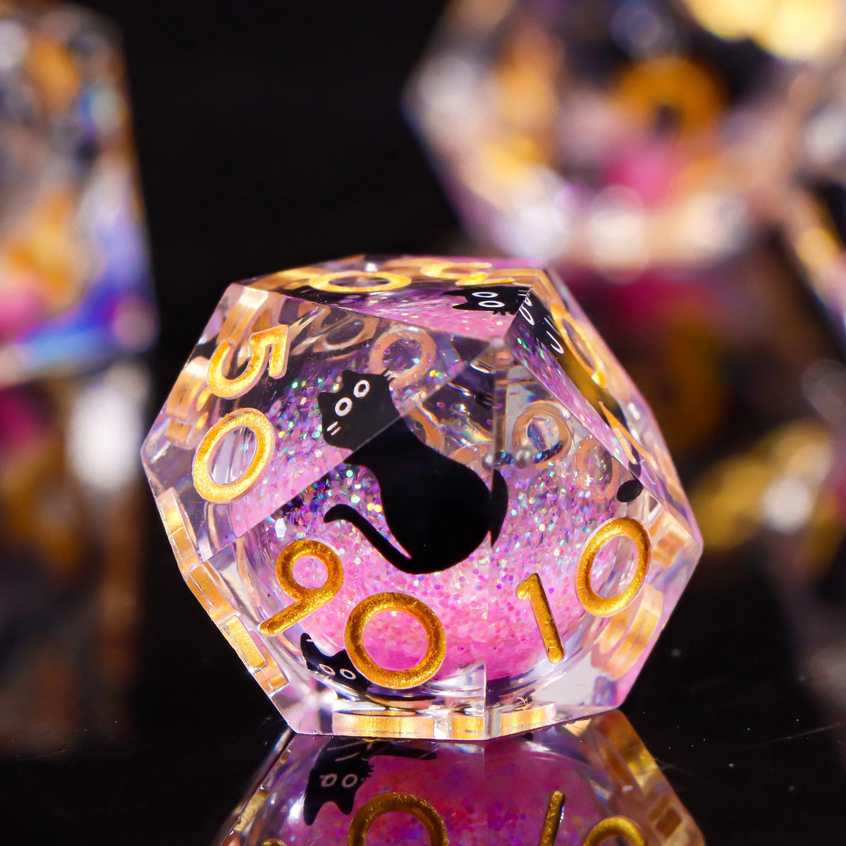 A close-up of a translucent purple polyhedral die with a black cat design and gold numbers, reflecting on a dark surface.