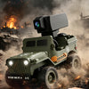 A hand holds a smartphone controlling a green 1:64 scale RC Jeep Willys 4WD off-road crawler in a dusty, outdoor setting.