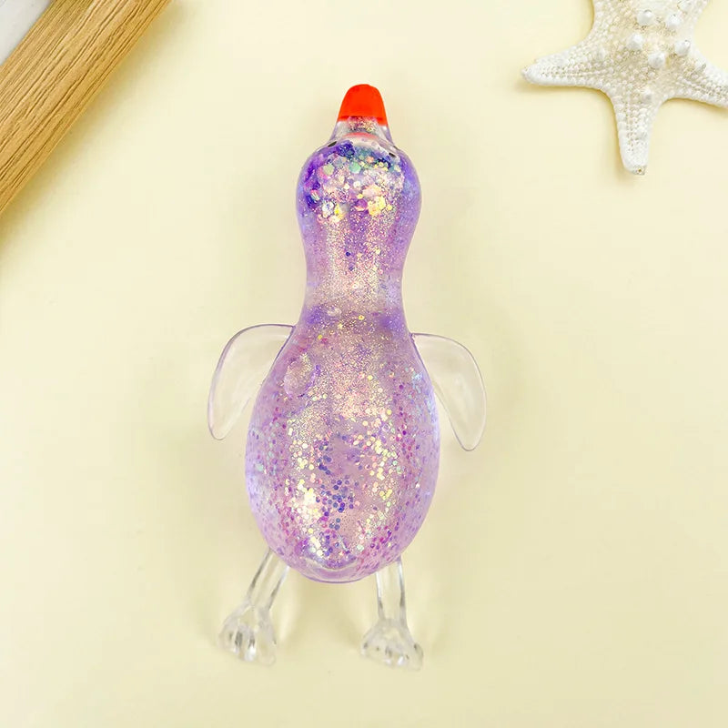 A purple, glittery stretchy duck squeeze toy with an orange beak and translucent feet.