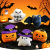 Halloween plush keychain set featuring a ghost, pumpkin, and bat charms against an orange background.