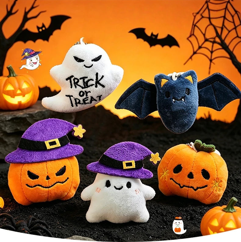 Halloween plush keychain set featuring a ghost, pumpkin, and bat charms against an orange background.