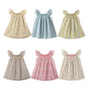 A collection of four girls floral smocked summer dresses with flying sleeves in various patterns and colors.