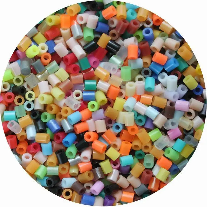 A colorful assortment of small plastic fuse beads used for crafting and pixel art puzzles.