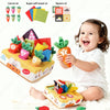 A baby is playing with a sensory toy box featuring carrot-themed items like soft towels, squares, and carrots.
