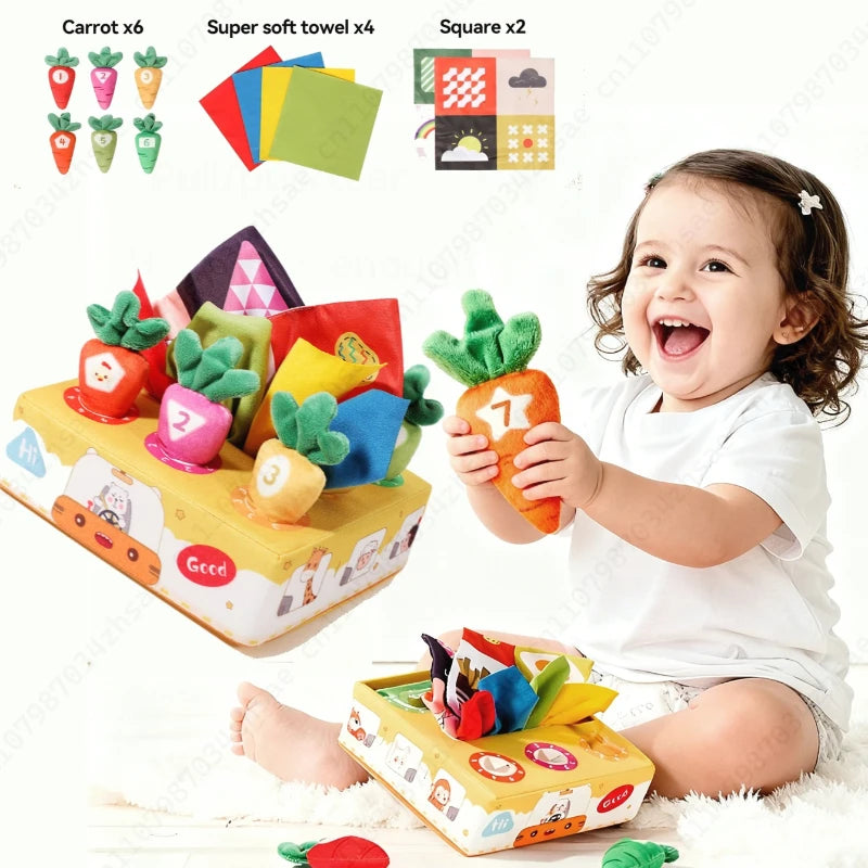 A baby is playing with a sensory toy box featuring carrot-themed items like soft towels, squares, and carrots.