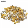 A pile of crystal rondelle spacer beads in gold and silver colors for jewelry making