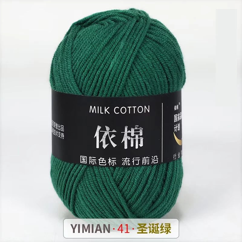 A ball of dark green milk cotton yarn labeled YIMIAN 41 for knitting and crochet