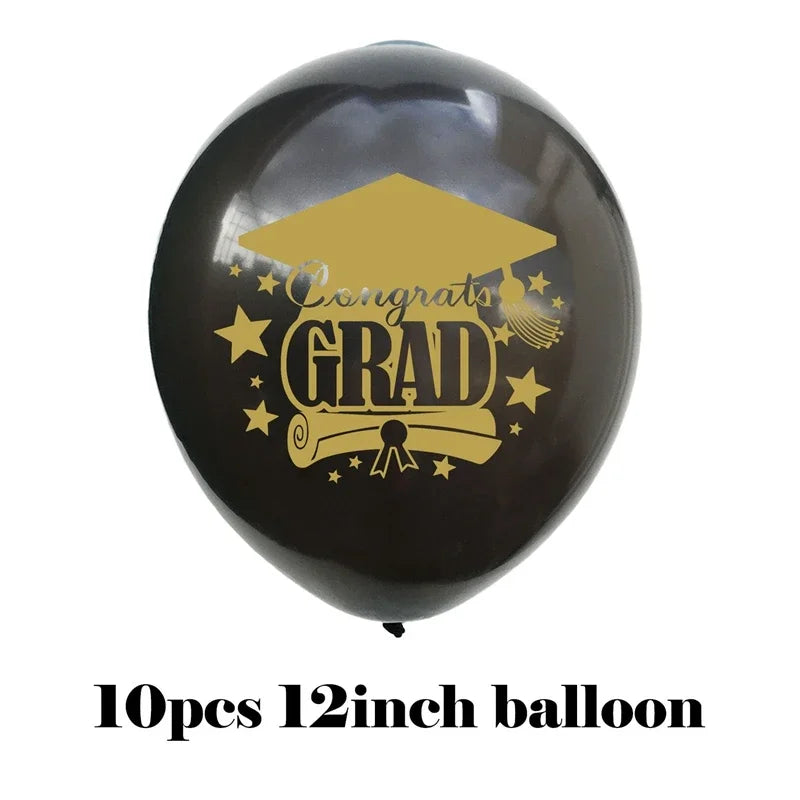 A black balloon decorated with gold text reading Congrats GRAD and stars, used for graduation party decor.