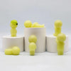 A collection of yellow glow-in-the-dark elf figures displayed in white cylindrical containers.