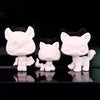A set of three white printable bobble head figurines displayed against a black background.