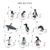 A set of nine realistic mini ocean animal figurines including a whale, shark, dolphin, turtle, and penguin.