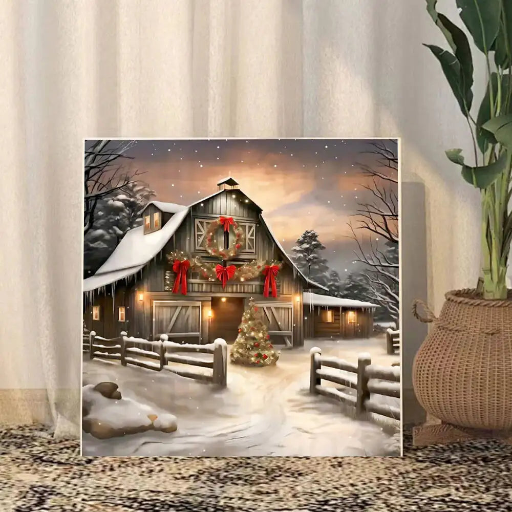 A winter scene of a wooden barn decorated for Christmas with snow and a festive sky.