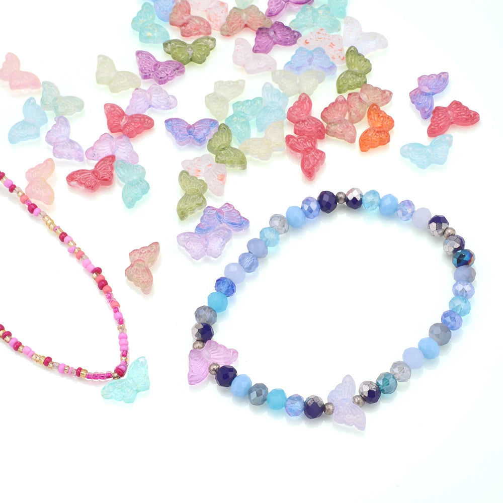 A scattered collection of multicolored glass butterfly beads for jewelry making