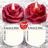 A set of two silicone molds shaped like red roses used for making candles, soap, and other items.