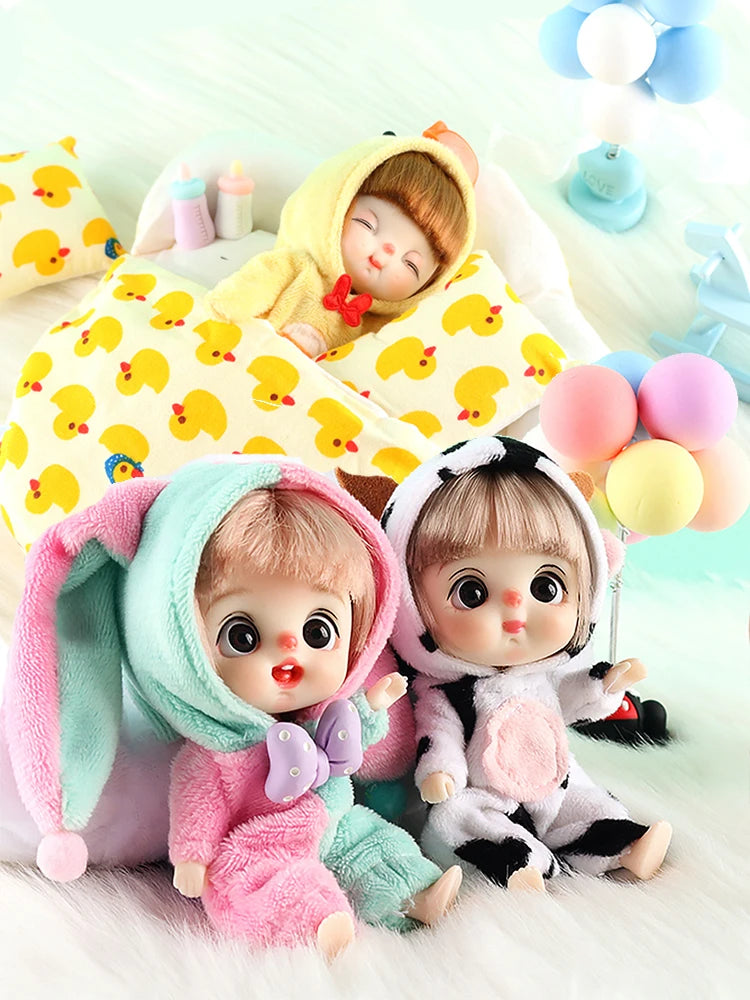 A set of mini smile dolls with poseable joints, featuring pink and yellow outfits and soft textures.